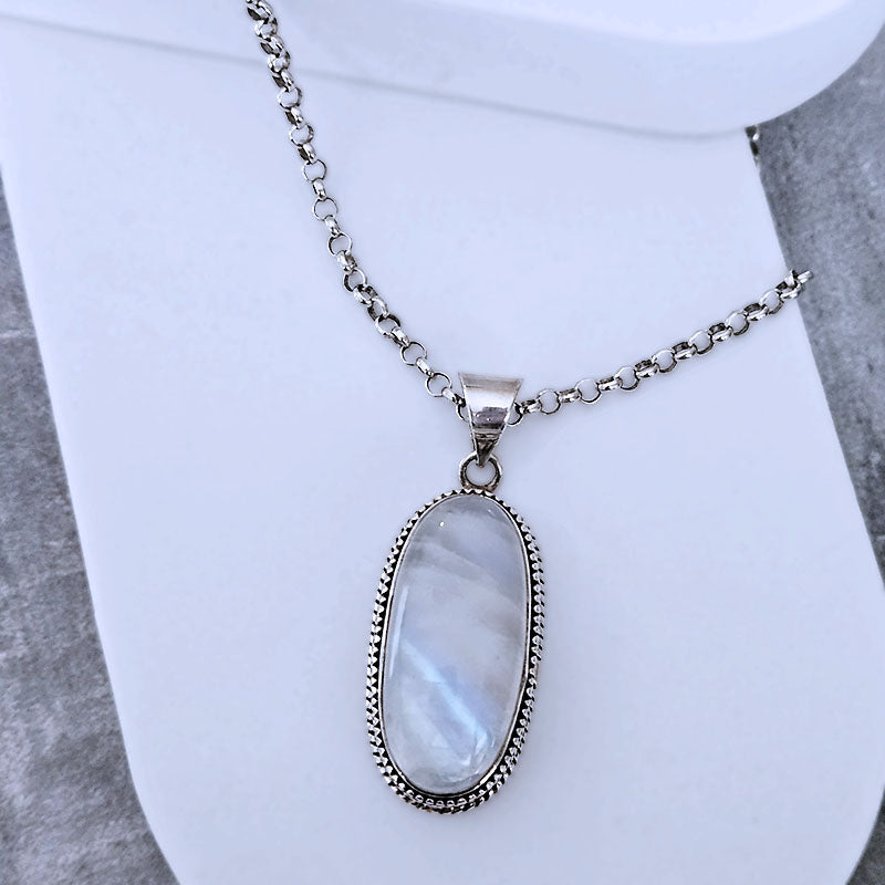 Necklace with an oval pendant on a mannequin bust against a white background