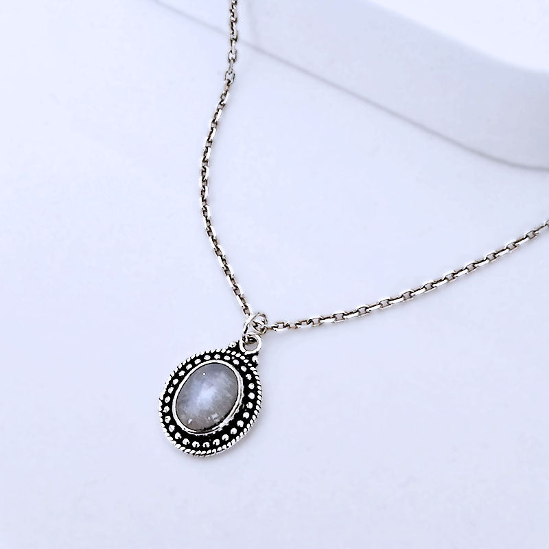 Silver necklace with a pendant on a white background