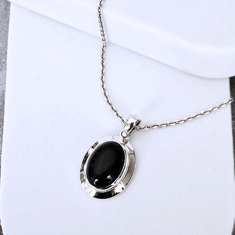 Necklace with a black pendant on a white background