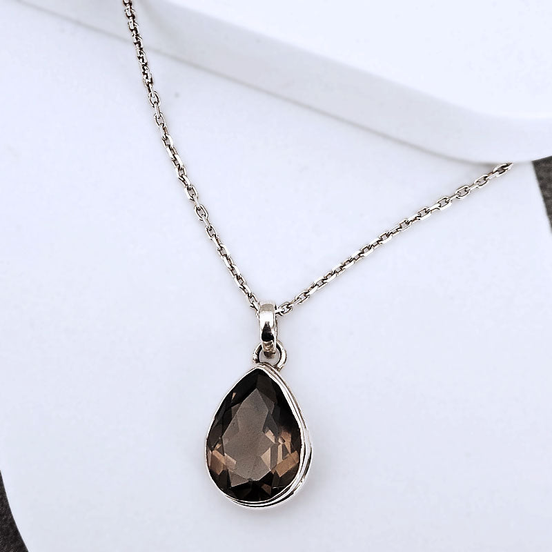 Necklace with a teardrop-shaped smoky quartz pendant on a white background