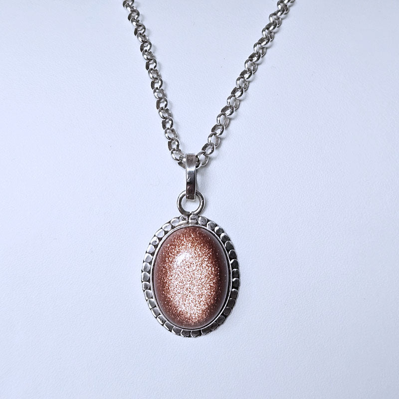 Necklace with a sunstone pendant on a light gray background