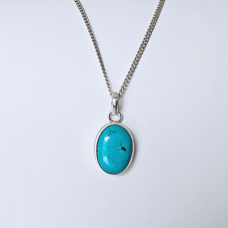 Turquoise pendant necklace on a white background