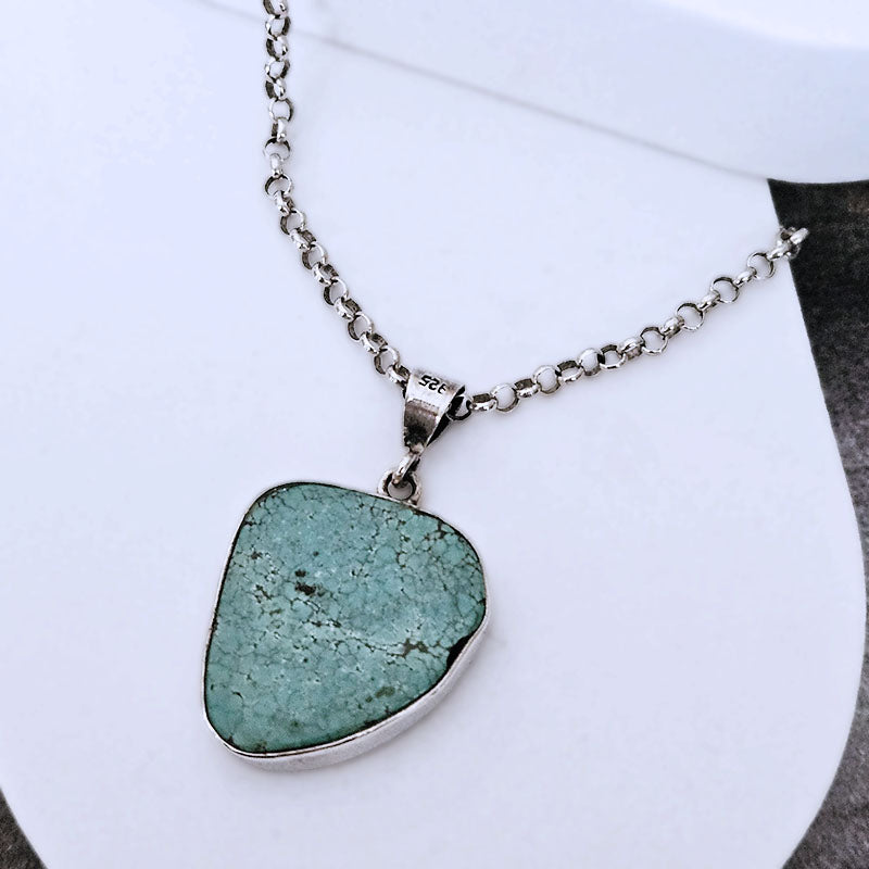 Necklace with a turquoise pendant on a white background