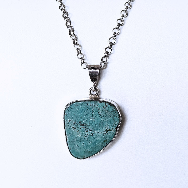 Turquoise pendant necklace on a white background