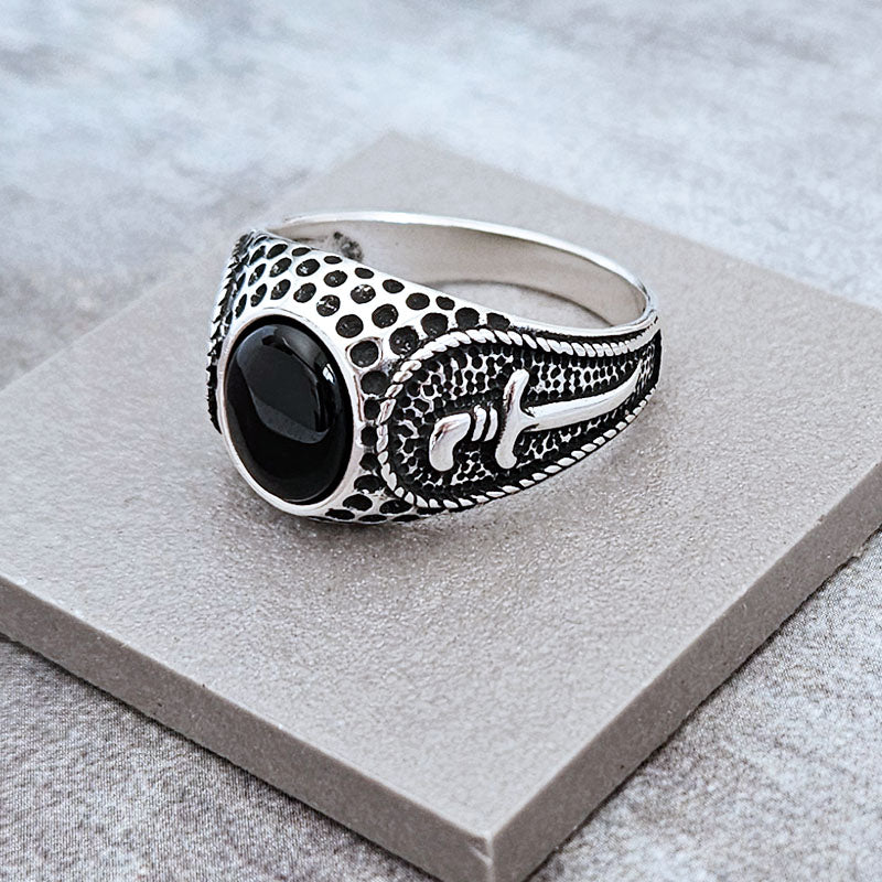Men's Ring with a black onyx stone and a textured dagger design