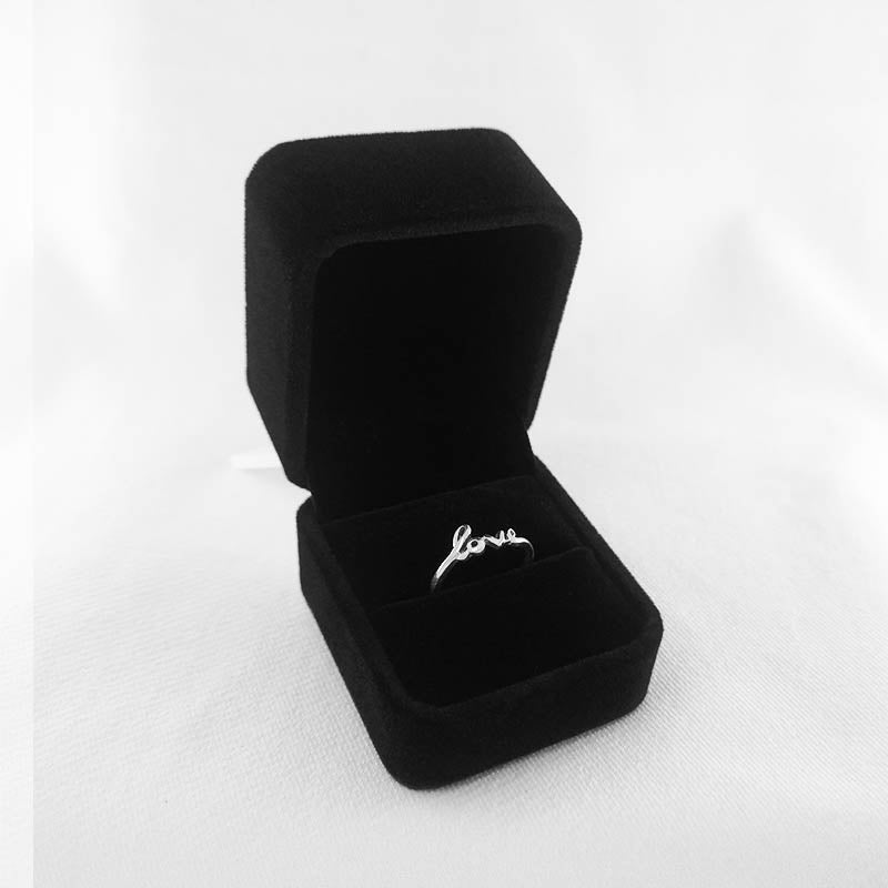 A luxurious velvet engagement ring box in rich burgundy, featuring a soft, plush surface.