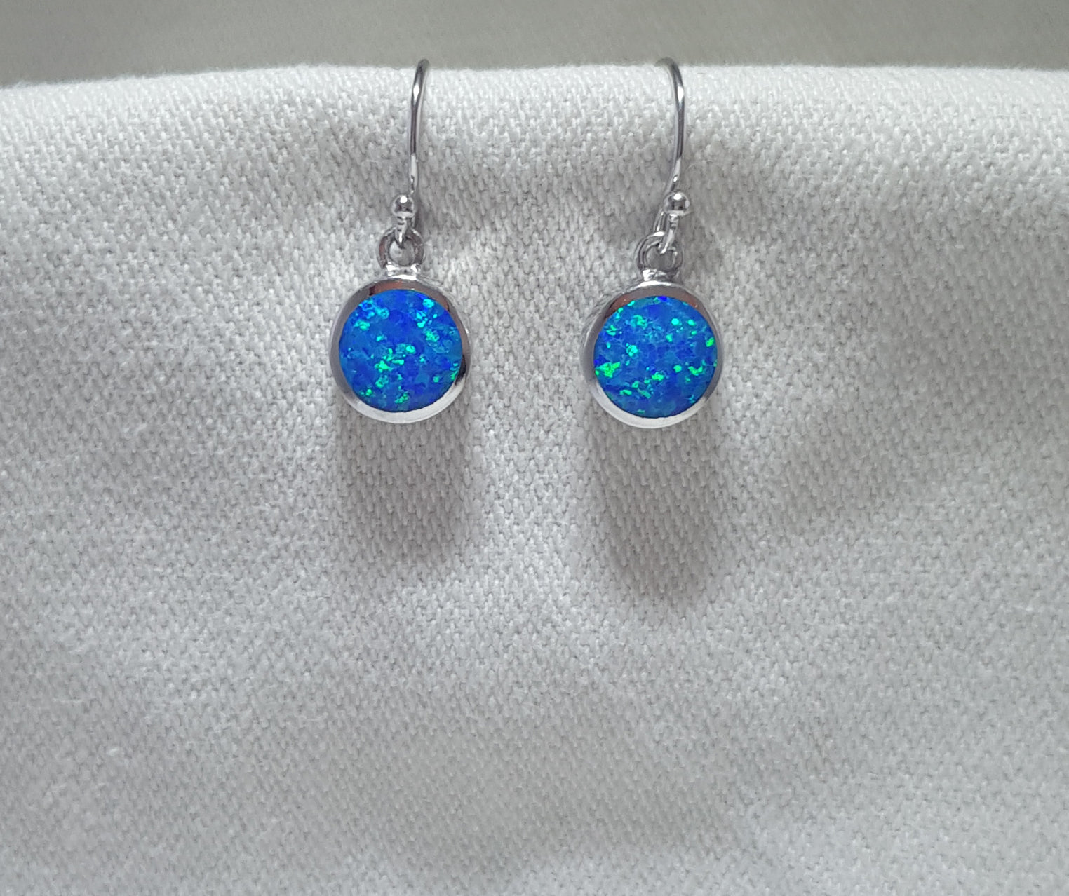 Elegant round crushed opal drop earrings, showcasing a captivating play of colors. 