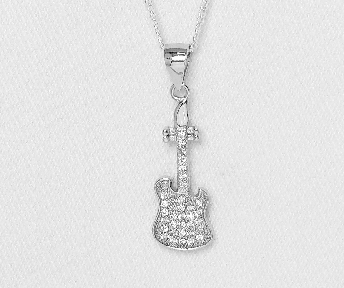 sterling silver guitar pendant with cubic zirconia stones.