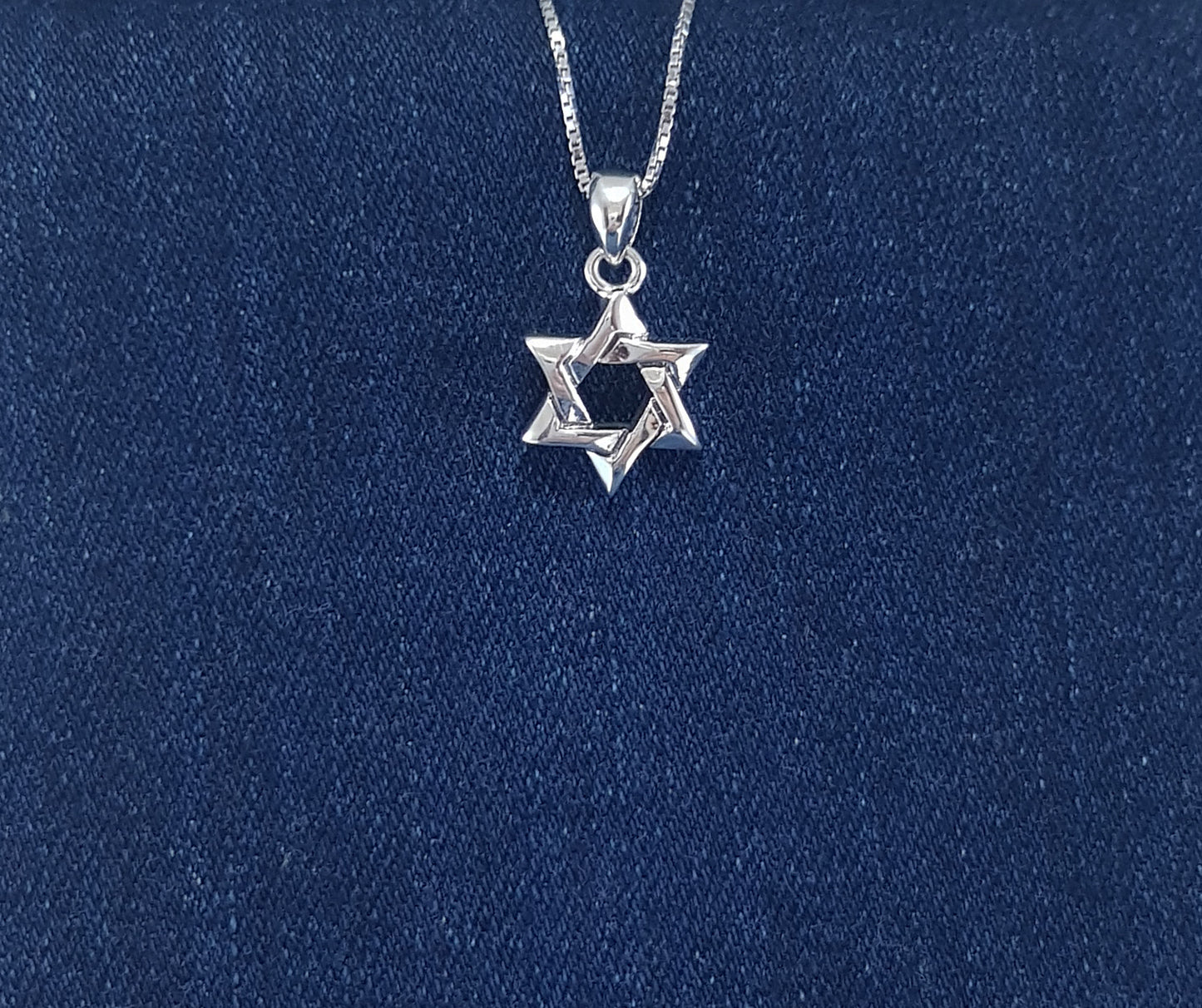 A dainty and elegant Small Star of David pendant, representing the Jewish faith and identity. 