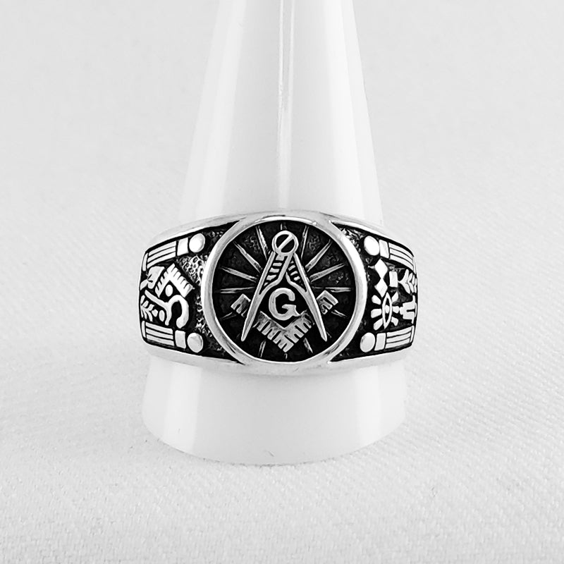 The ring features a prominent and eye-catching design that incorporates Masonic symbols such as the square and compass.