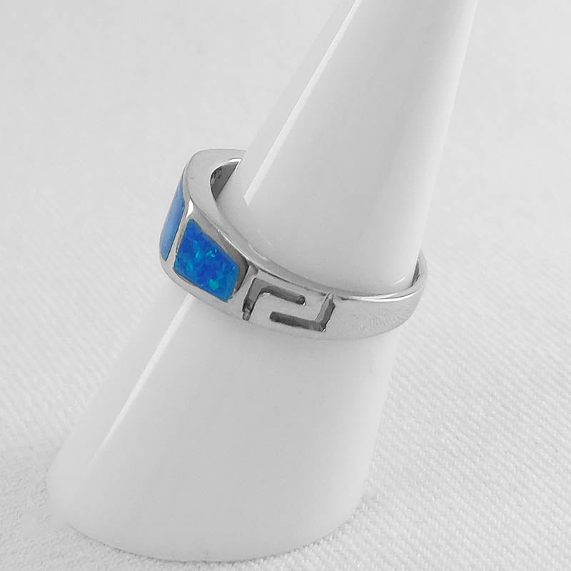 sterling silver band with blue opal inlay and a Greek meander pattern.